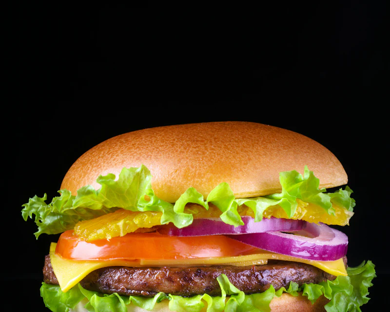Single beef patty burger with lettuce, tomato, onion and cheese