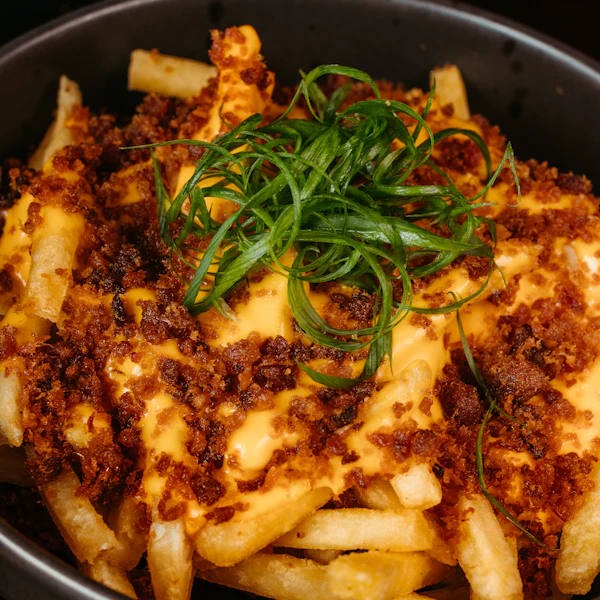 Loaded fries with cheese sauce, beef and spring onions