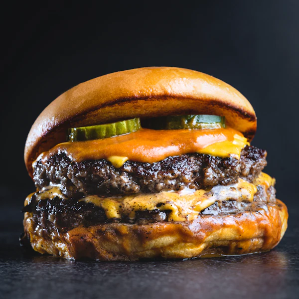 Double smash burger with pickles and dripping cheese